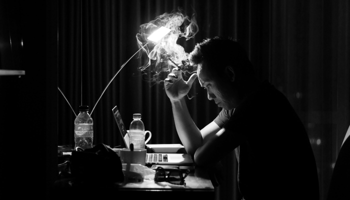 A Guy Smoking and Working