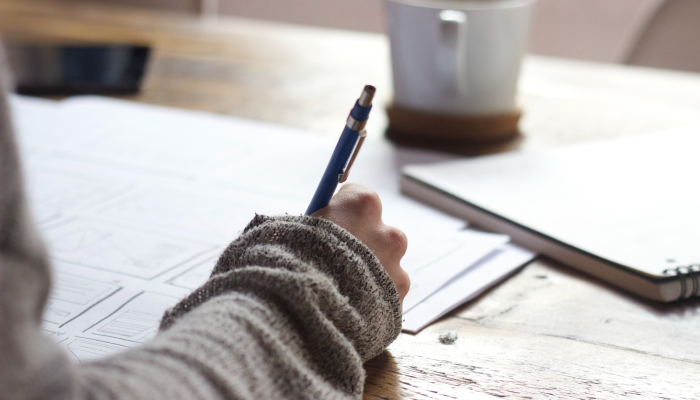 A Girl Wiring in a Notebook